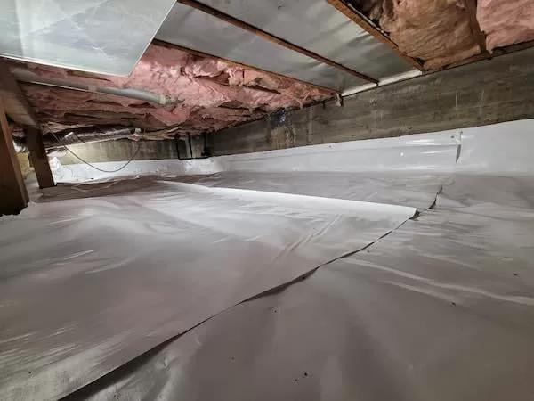 Under house crawl space with white plastic membrane on all of the ground In Lake Oswego