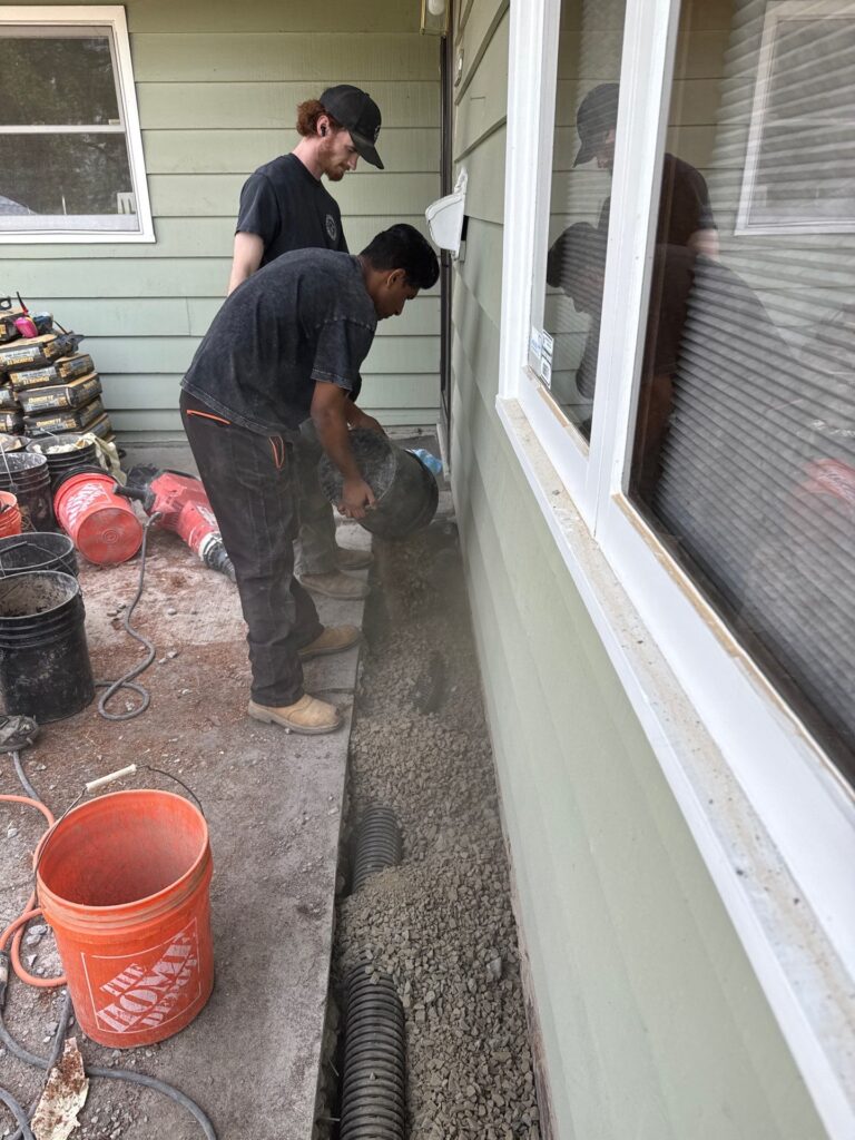 Better Basement and Waterproofing crew completing basement waterproofing installation in Portland Oregon home