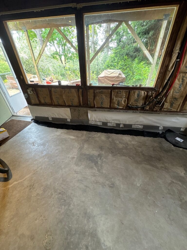 how to waterproof a basement from inside Portland Oregon showing drainage channel along perimeter floor by Better Basement and Waterproofing